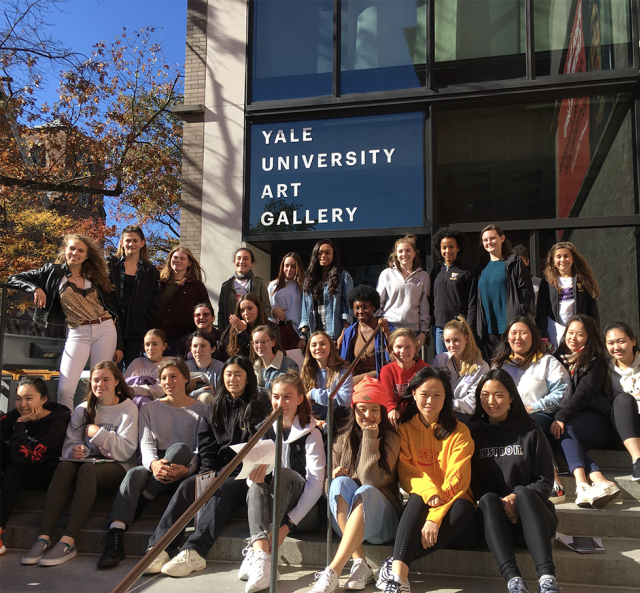 students outside of the building sitting on stairs