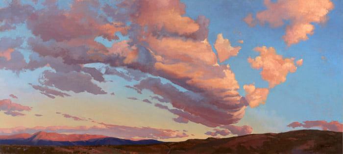 a very beautiful landscape painting with the clouds showing the colors of sunset and the desert mountains