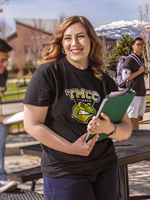 Woman on campus holding books