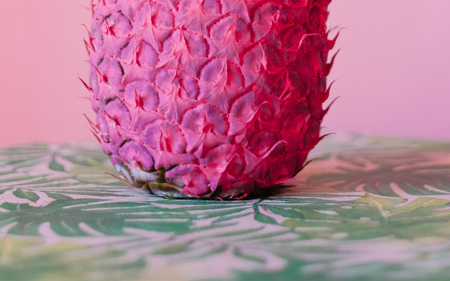 A pink pineapple sitting on a table.