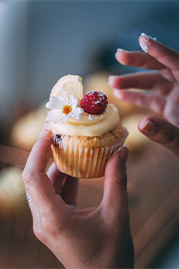 image of someone holding lemon cupcake