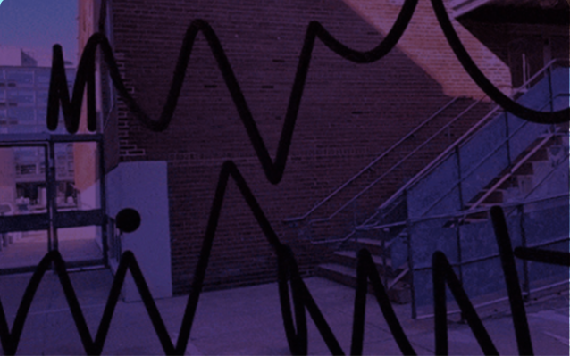 back of a building, with a staircase towards the right, and black squiggly lines above the back of the building photo.