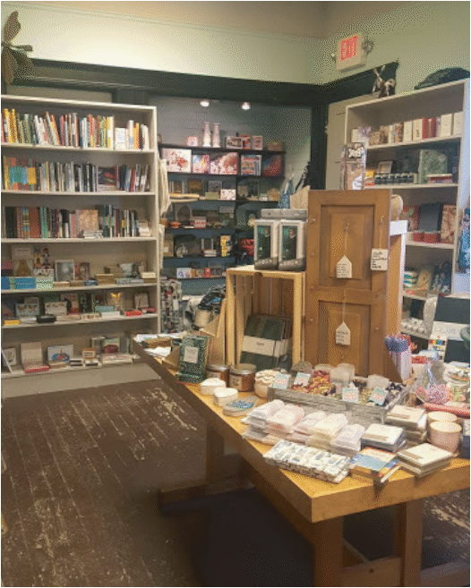Another interior shot of the store is shown. It is taken from the open entrance at the back of the store in the little gift shop and kitchen area. Small knick knacks for sale are shown.
