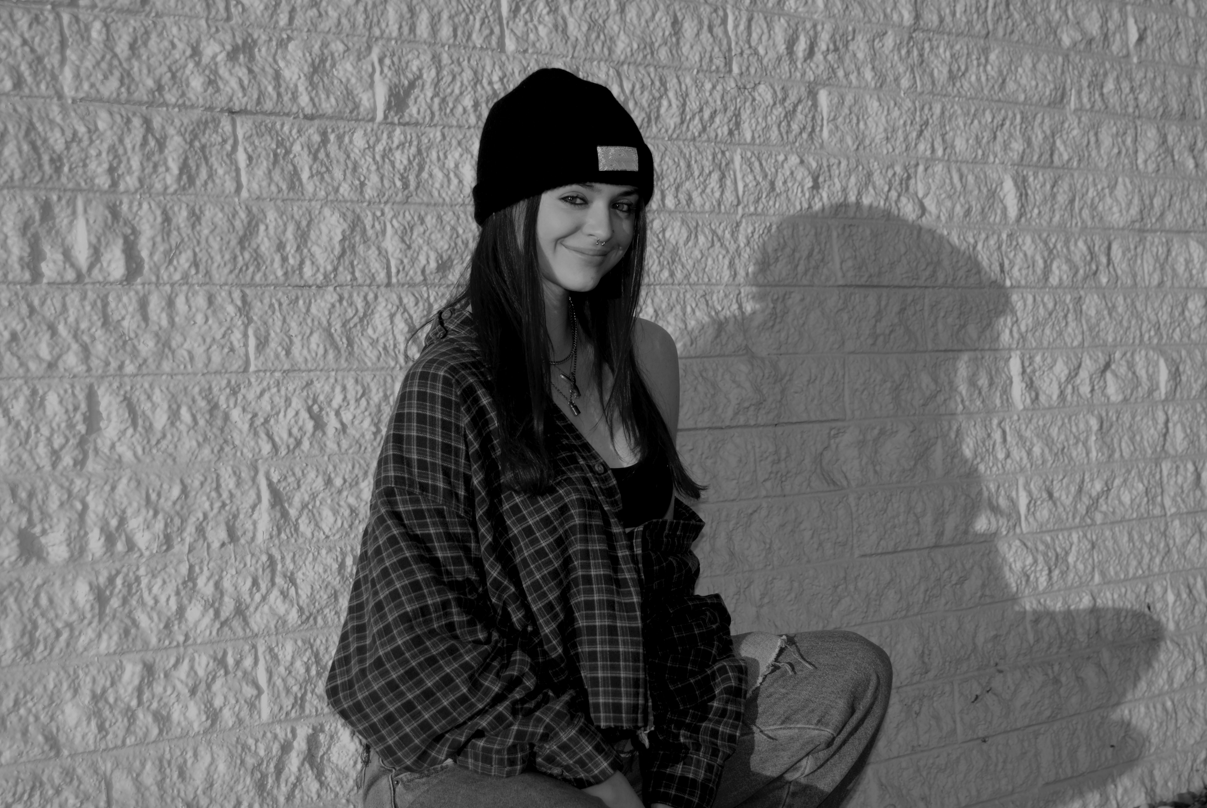 a black and white image of Bella Meyer, the graphic designer, sitting down.