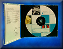 aA CD case is opened showing the CD inside.The CD has pictures of xray images and very small words on the front of it